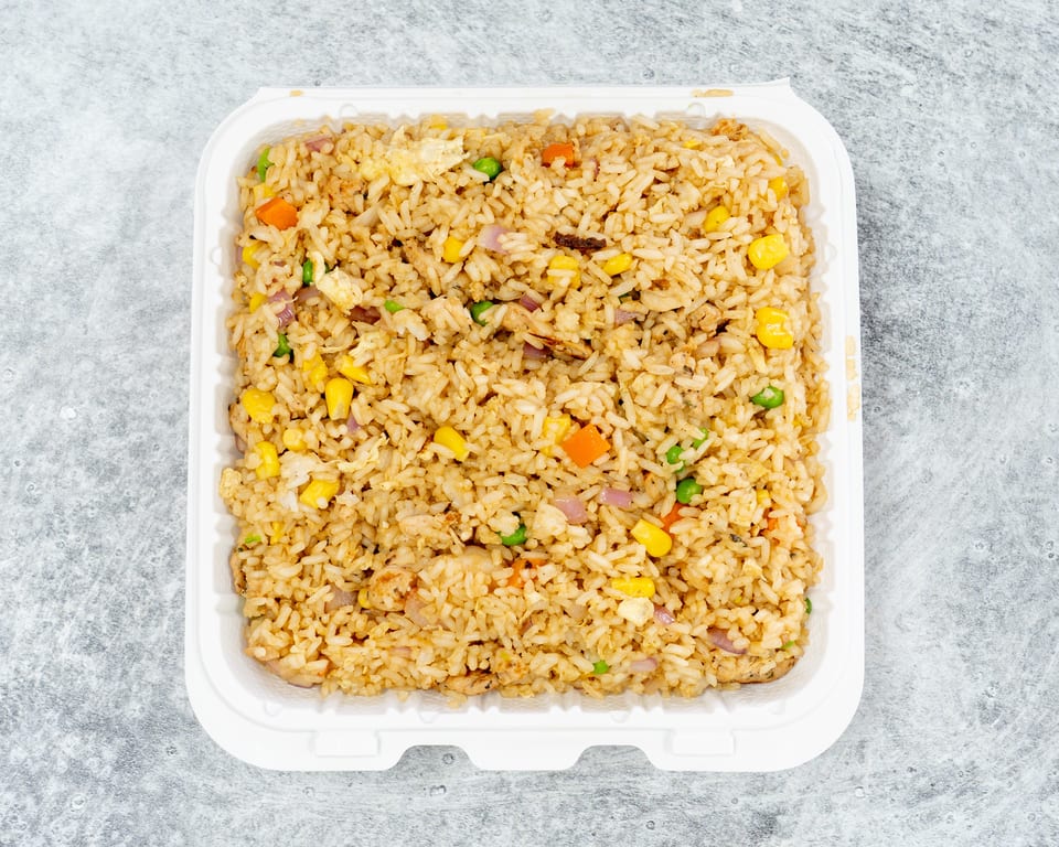 Chicken fried rice with vegetables in a takeout container
