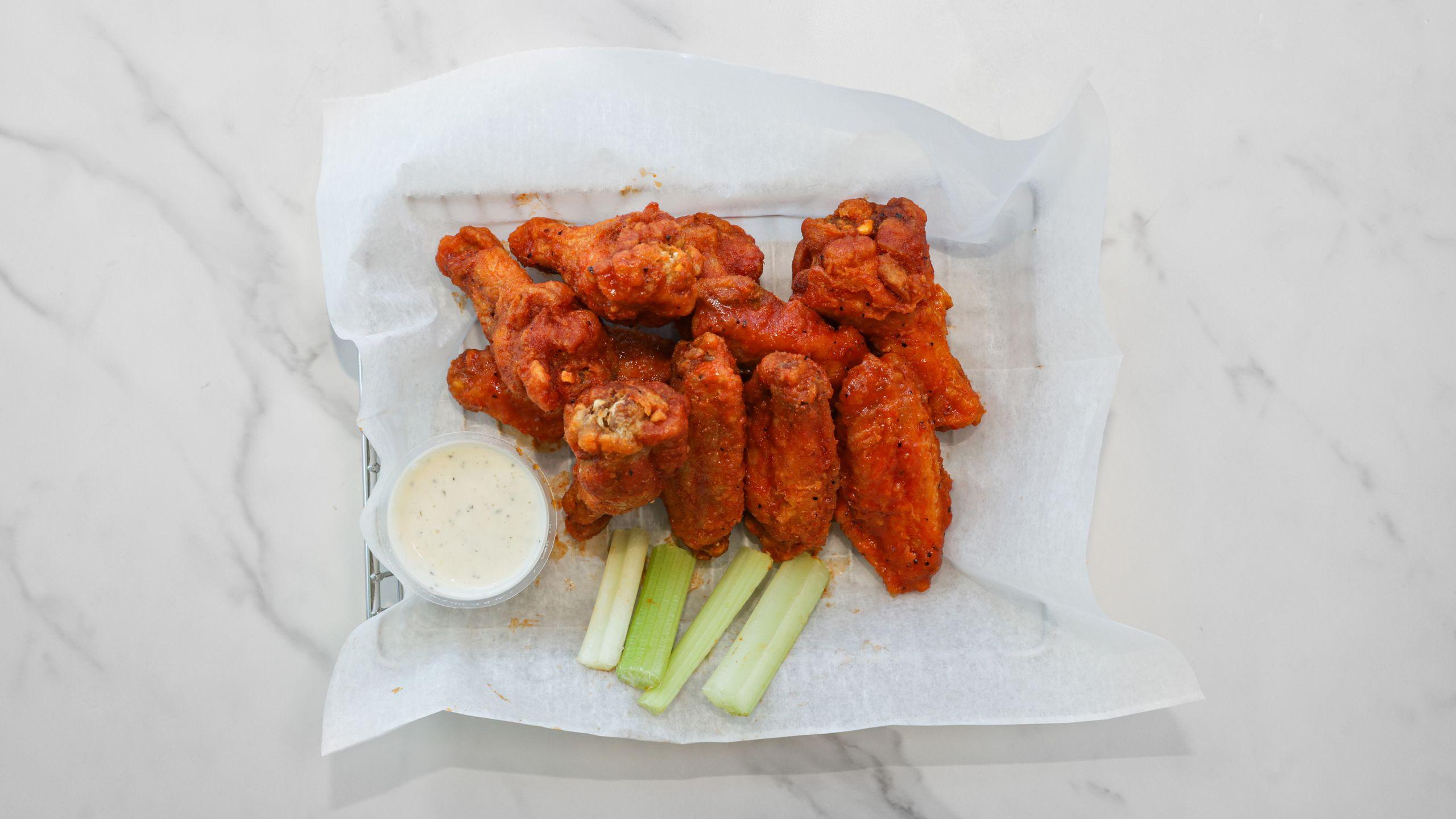 Ten sauced wings with celery and dipping sauce